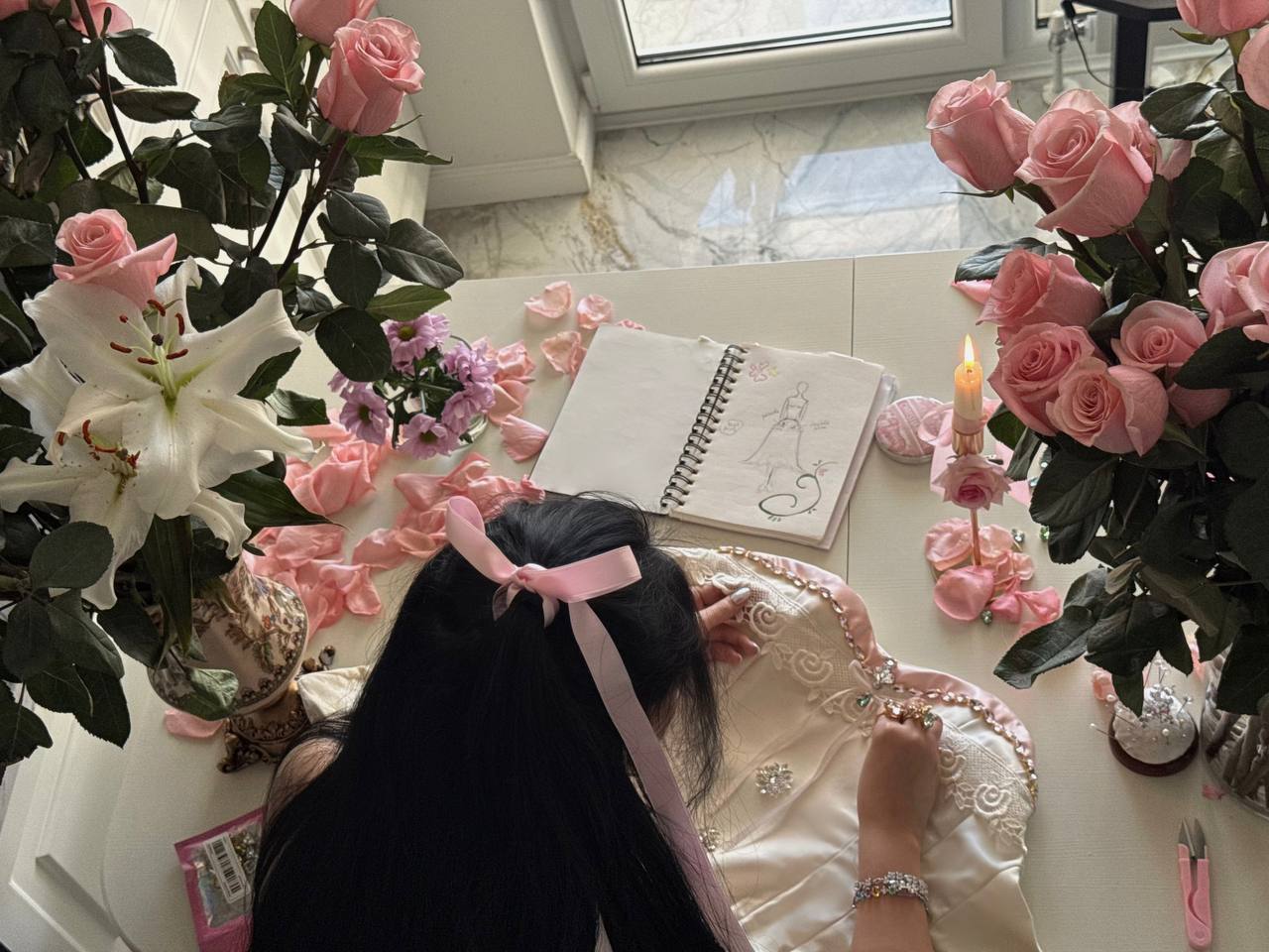 Sketchbook, roses and a corset in the atelier